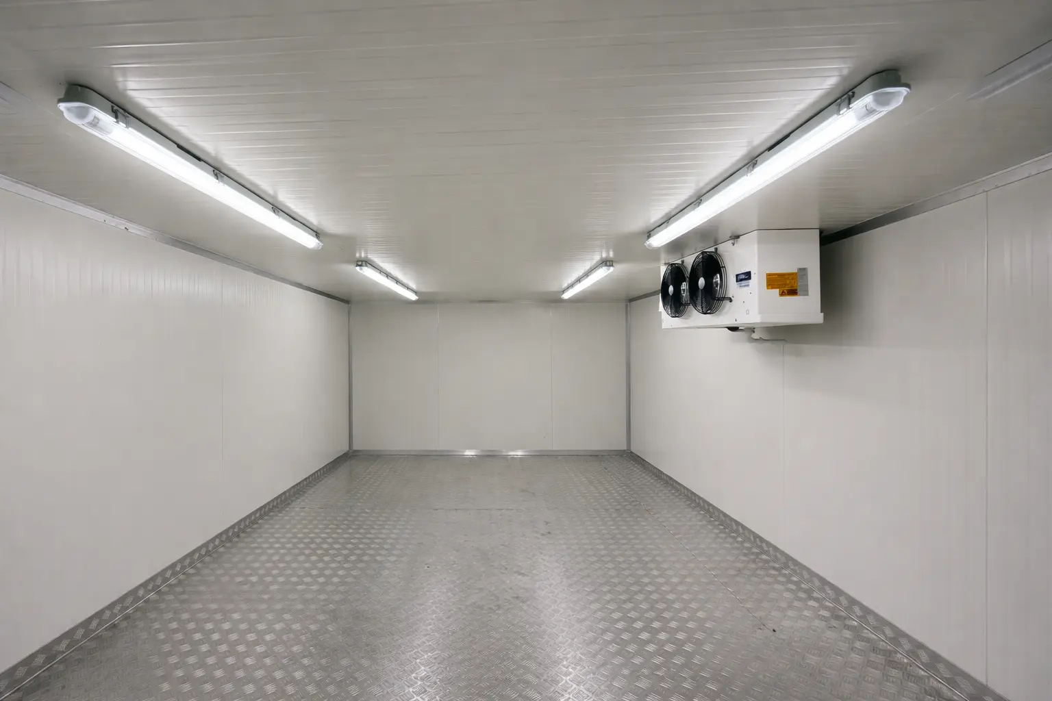 Chiller room interior showing uniform lighting, insulated panels and ceiling-mounted cooling unit for airflow distribution in Dubai