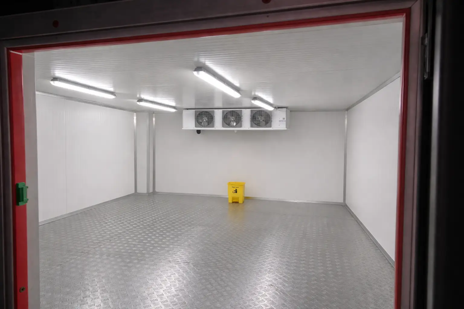 View inside a chiller room from the entrance showing sealed door frame, cooling unit and insulated interior in Dubai