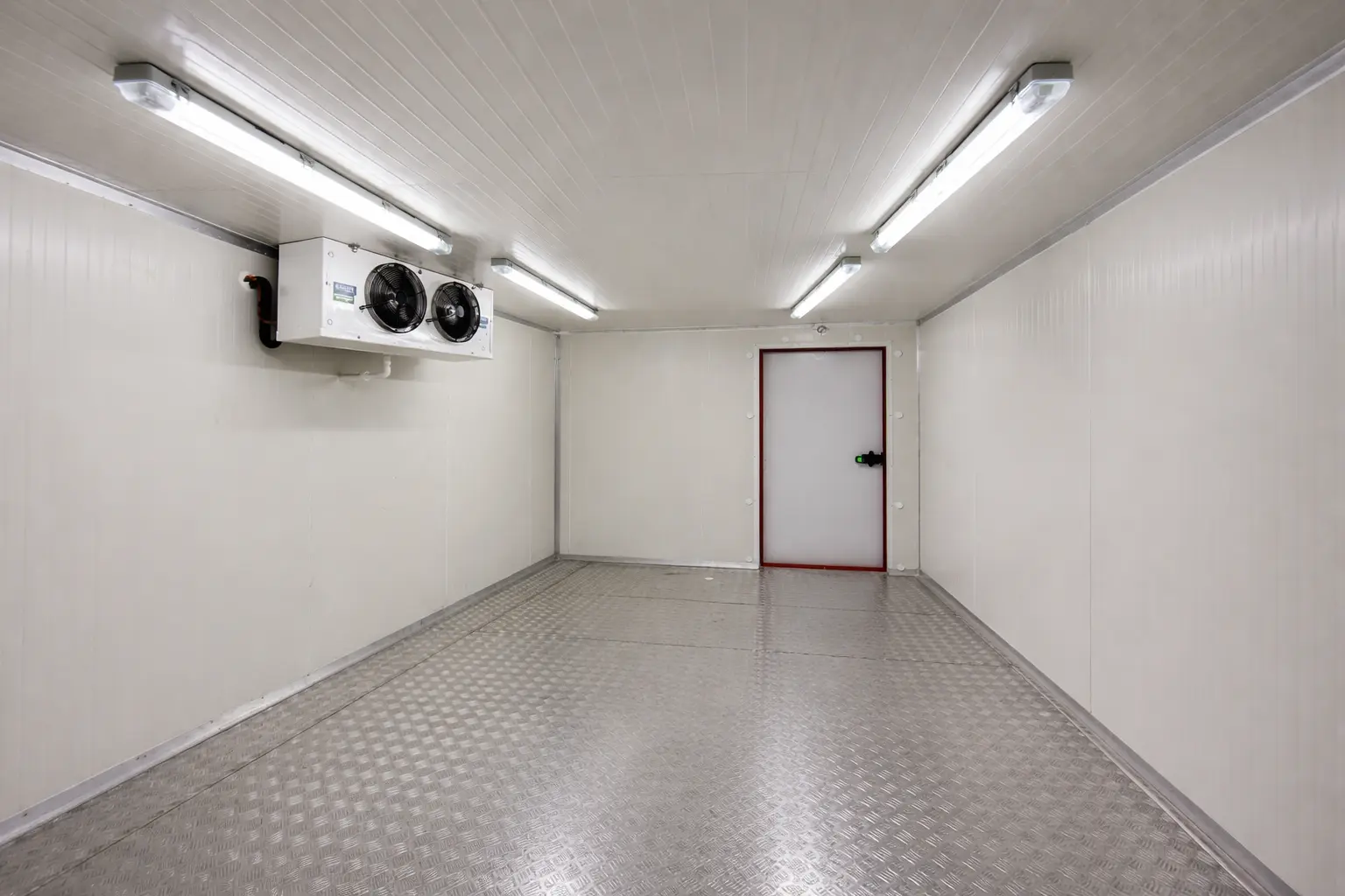 Interior layout of a walk-in chiller room with side-mounted cooling unit, insulated panels and sealed door in Dubai
